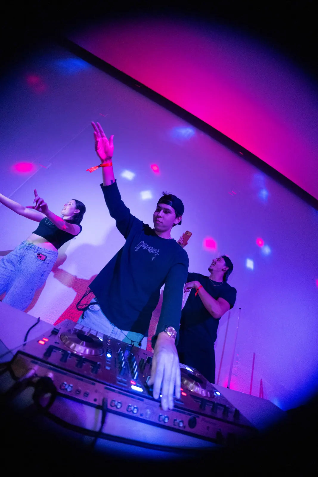 DJ and crowd under purple lights