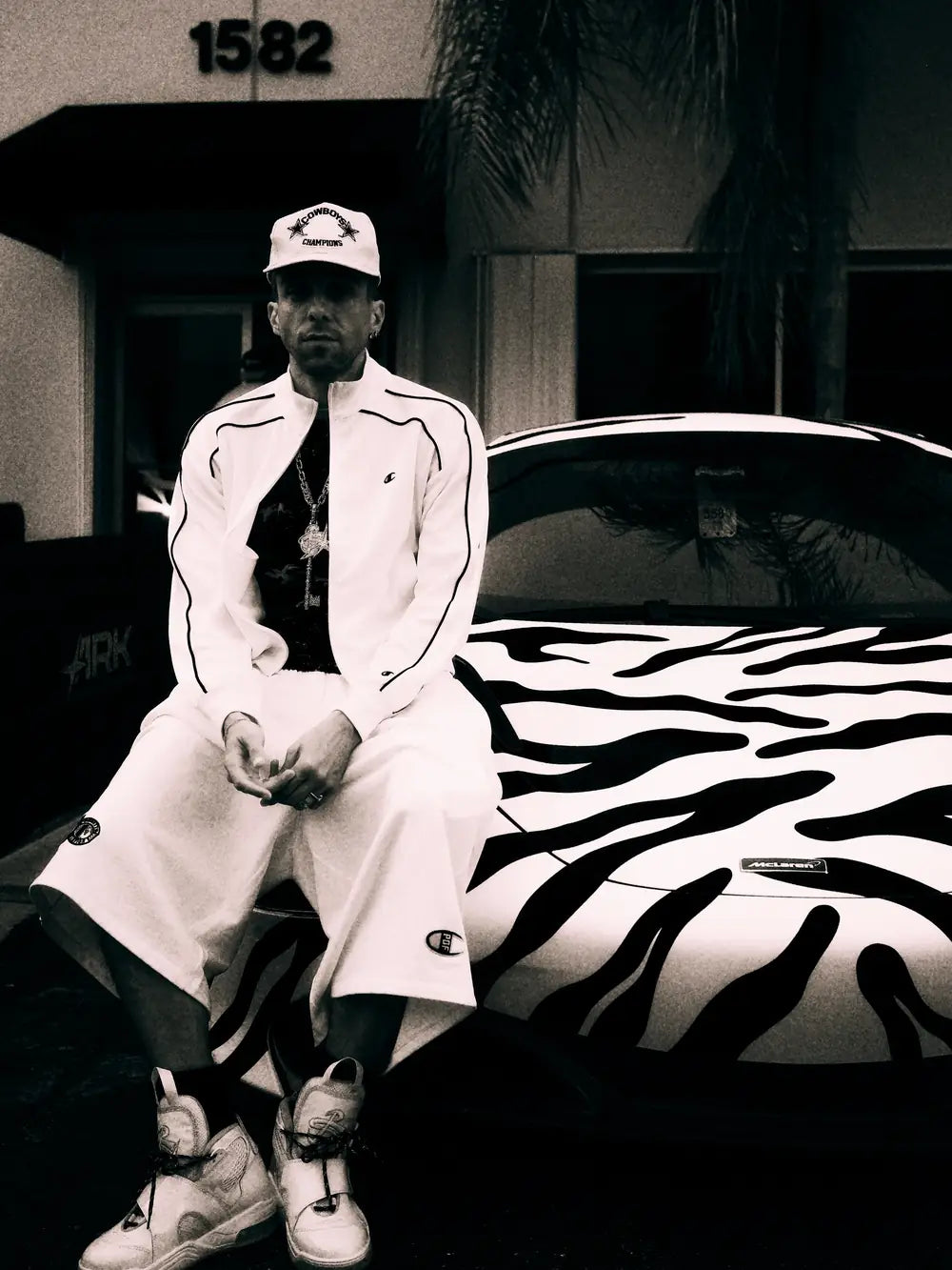 Domenico Formichetti beside the zebra-wrapped car at Ark