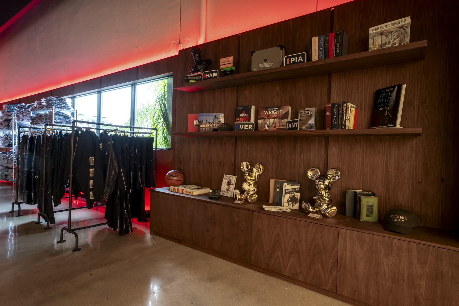 Curated upstairs library and apparel display inside the Safe House
