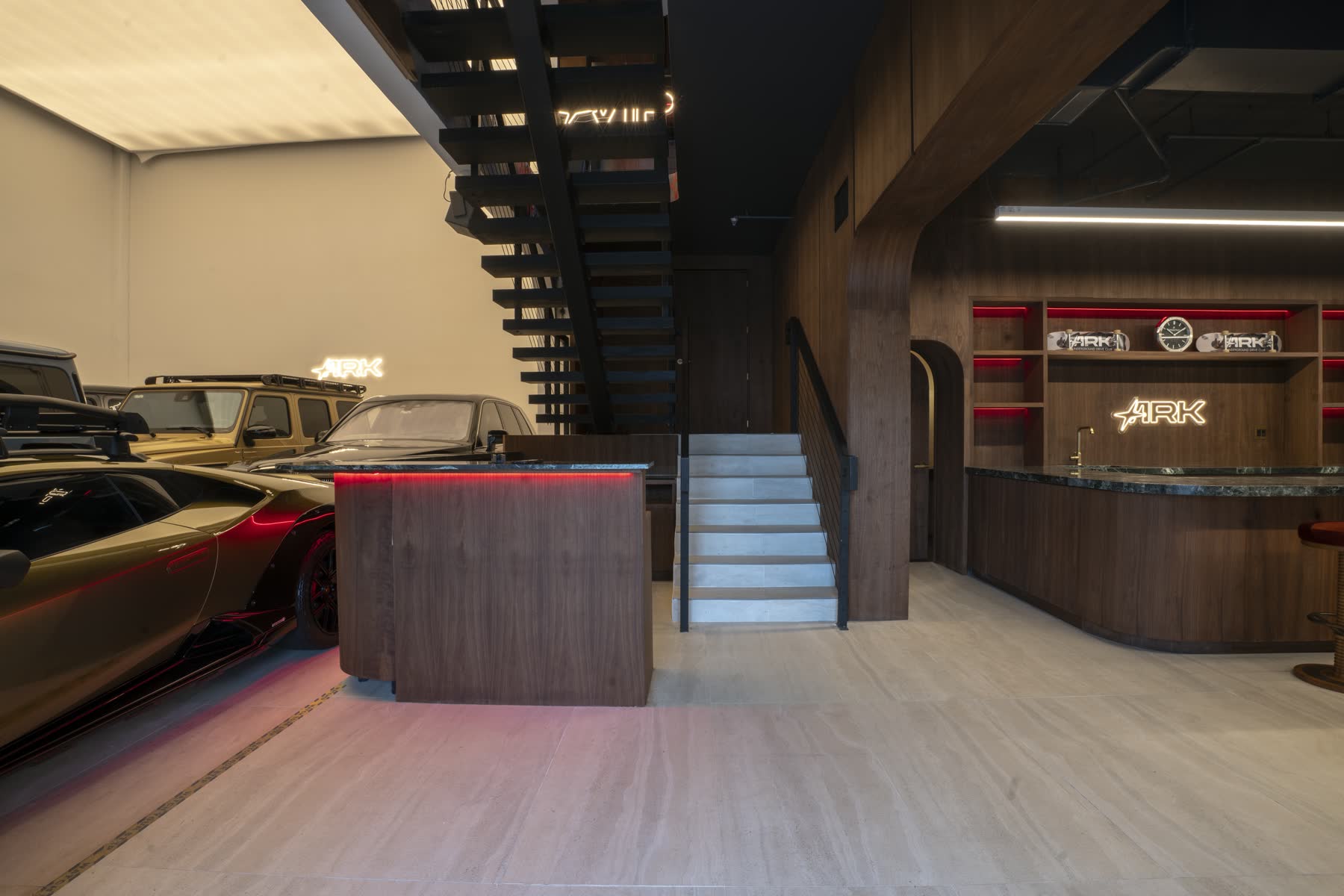 Safe House reception entrance and central staircase beside parked vehicles